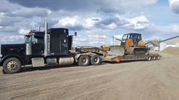 Lowboy hauling bulldozer